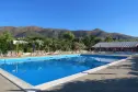 Panoramablick auf das Schwimmbad mit den ligurischen Hügeln des Campingplatzes Bella Vista im Hintergrund