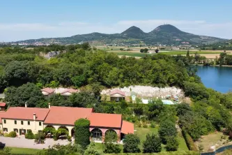 view of the small lake and the Agriturismo Alba in the Euganean Hills Park in Baone