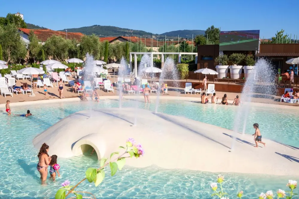 view of the swimming pool area with maxi screen of the HU Firenze Camping in Town in Tuscany