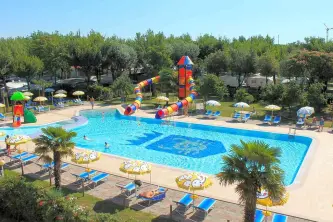 swimming pool with slides of the camping park capraro in jesolo