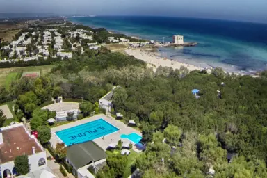 view of the swimming pool, beach and sea of ​​the Camping Village Il Pilone in Ostuni in Puglia