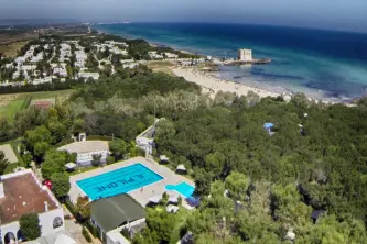 view of the swimming pool, beach and sea of ​​the Camping Village Il Pilone in Ostuni in Puglia